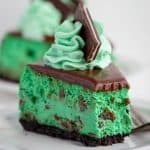 bite taken of mint chocolate cheesecake on a white plate