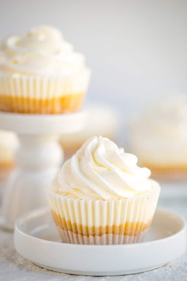 no bake mini lemon cheesecake in cupcake liner on white plate