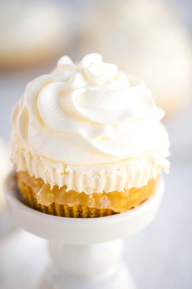 no bake mini lemon cheesecakes on a white cupcake stand