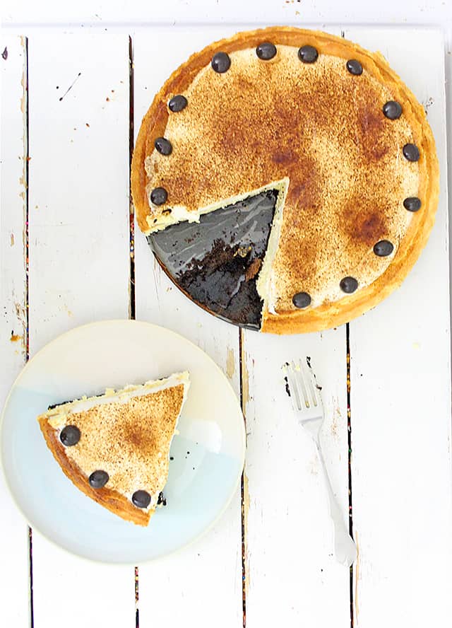 overhead of whole espresso cheesecake and slice of espresso cheesecake on a dessert plate