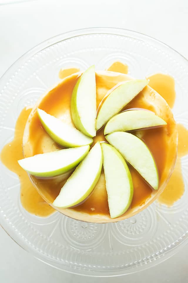 Overhead of instant pot caramel apple cheesecake with apples and caramel on cheesecake