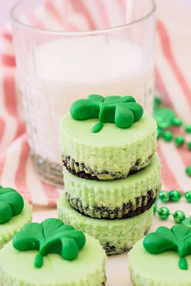 stack of mini mint cheesecakes with a glass of milk