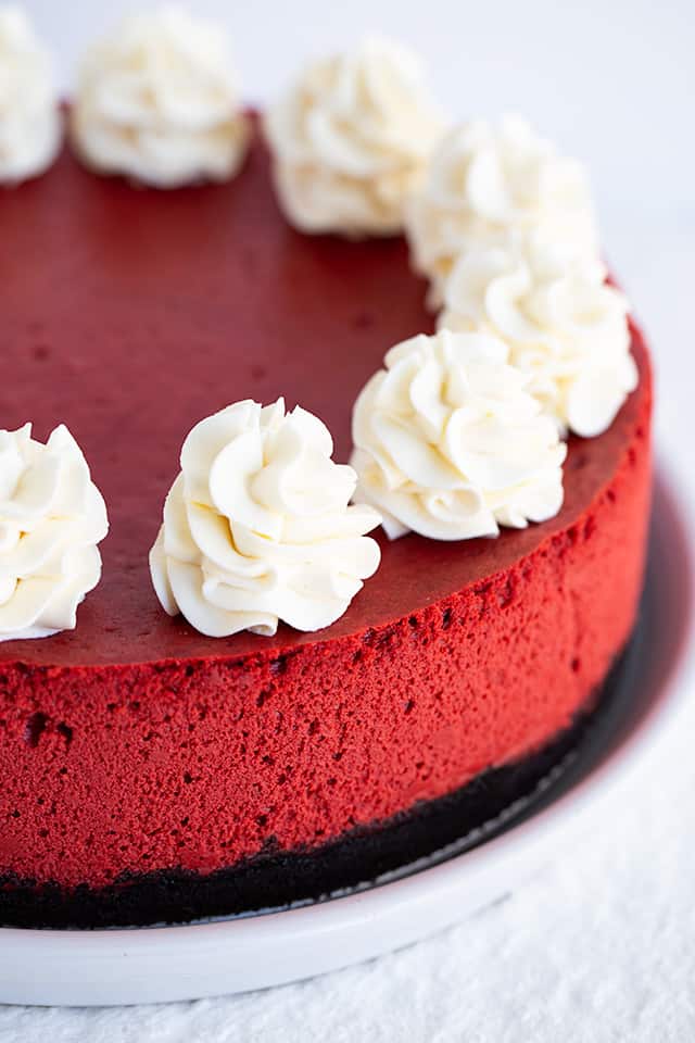 red velvet cheesecake on a white serving plate