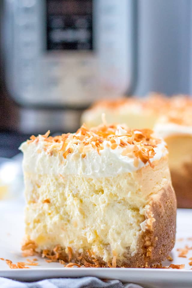 slice of pina colada cheesecake with instant pot in background