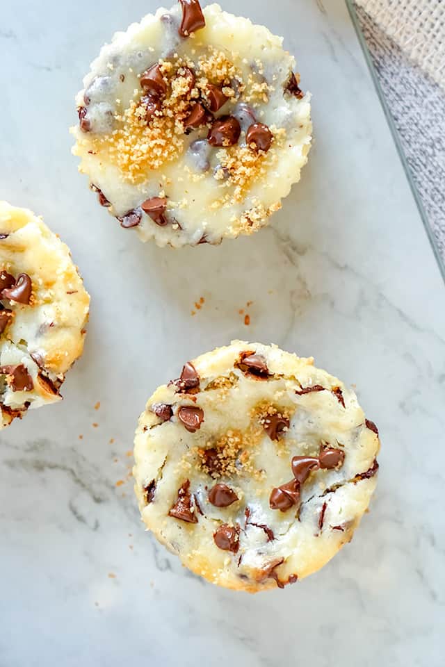 overhead of mini chocolate cheesecakes on marble background