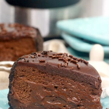 close up of chocolate cheesecake on a blue plate with other blue plates behind it