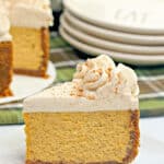 slice of pumpkin pie on a white square plate with green linen