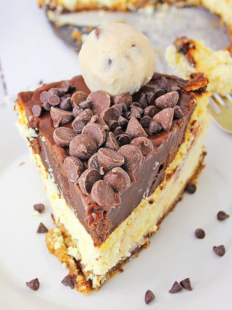 up close photo of a slice of cheesecake showing the top of the cheesecake with the chocolate chips and edible cookie dough balls