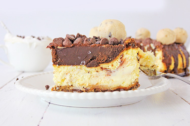 horizontal photo of the side of a cheesecake on a white plate with a bowl behind it