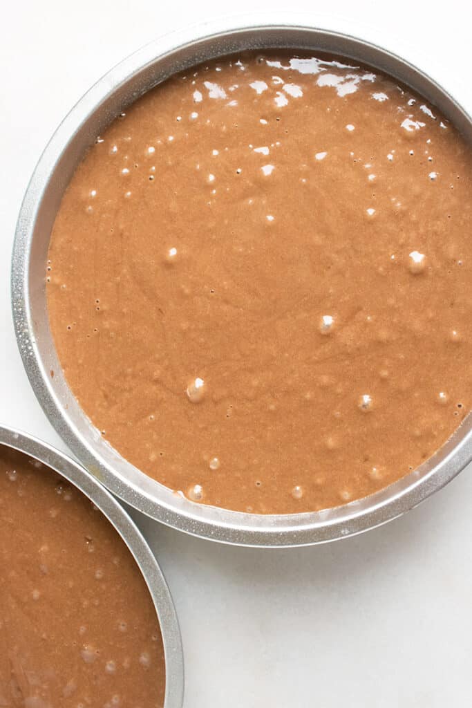 pan full of chocolate cake batter on a white background