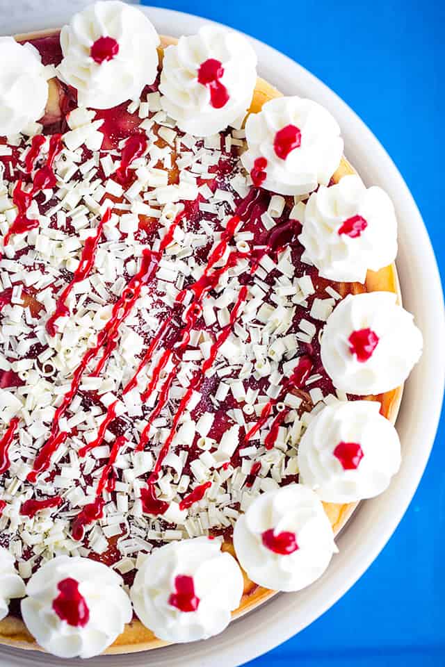 overhead photo of a cheesecake with a blue background