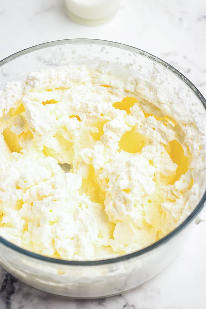 no bake cheesecake batter on a glass bowl on a white surface