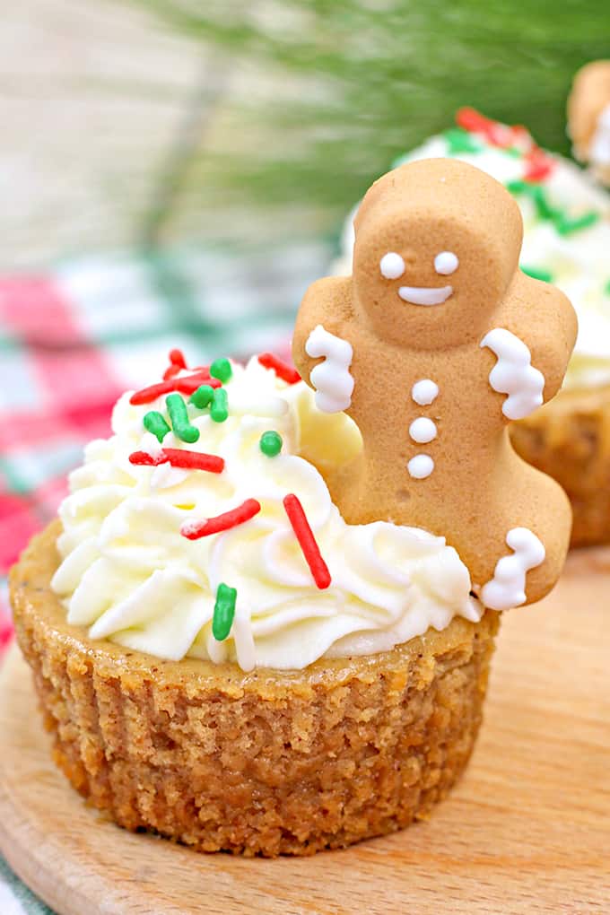 close up of mini molasses cheesecakes decorated for Christmas on a cutting board